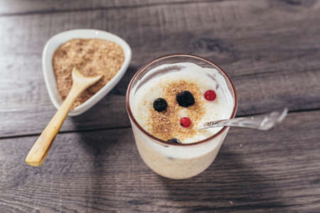Fresh yogurt with wheat bran and banana and berriesの写真素材