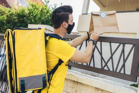 Young man delivering online grocery order.の写真素材
