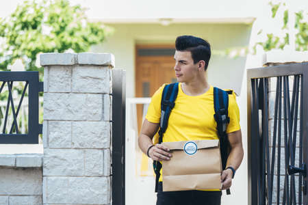 Young man delivering online grocery order.の写真素材