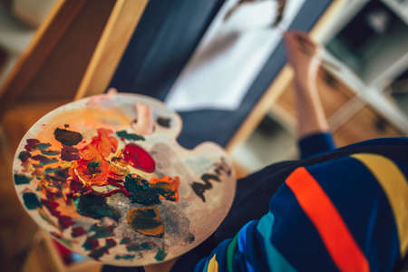 Cute little boy painting a picture in home studioの写真素材
