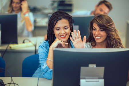 College students sitting in a classroom, using computers during class.の写真素材