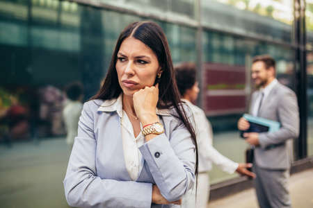 Young businesswoman with serious expresison standing at the city.の写真素材