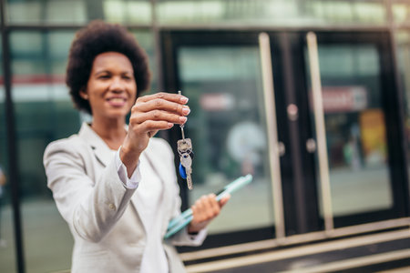 Sold house key and blurry home on backgroundの写真素材