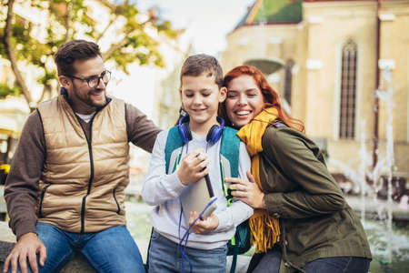 Young parents taking their little child to schoolの写真素材
