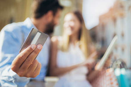 Young couple using a digital tablet for online shopping outdoor.の写真素材