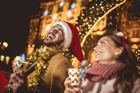 Young romantic couple is having fun outdoors in winter before Christmas.の写真素材