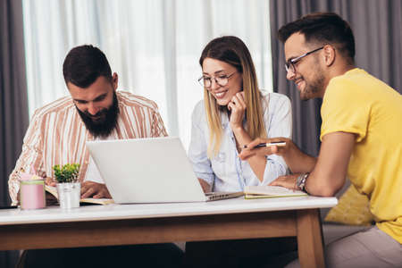 Group of young students preparing for exams in home interior