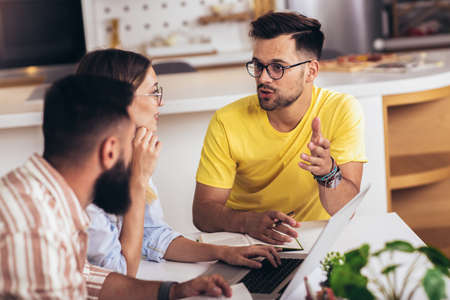 Group of young students preparing for exams in home interior