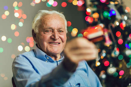 Senior man shopping online with credit card on Christmas.の写真素材