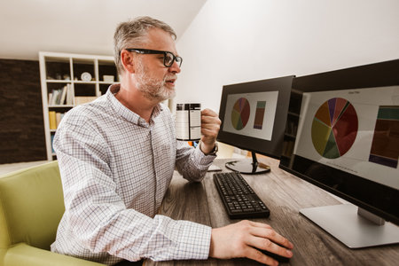 Photographer with beard, while working in his office at home.の写真素材