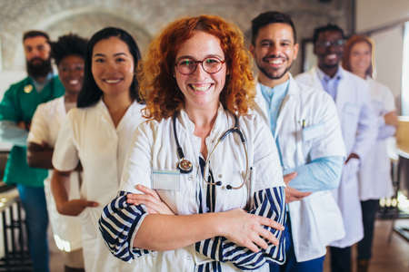 hospital, profession, people and medicine concept - group of happy doctors at hospital