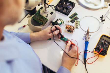 Engineer fixing broken computer equipment. Electronic repair shop, technology development concept