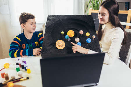 Kid presenting his science home project - the planets of our solar system. Distance learning online...