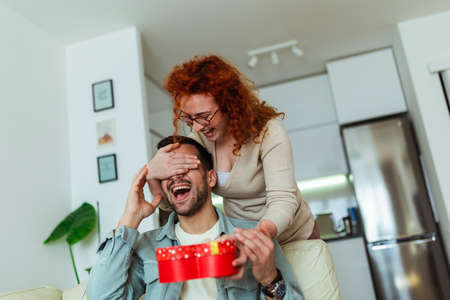 Young couple at home celebrating Valentine's Day. Romantic day together.の写真素材