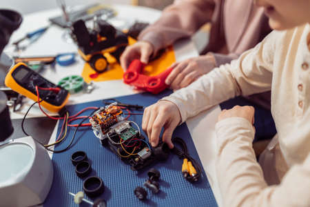 Close up photo of children making robot at home.の写真素材