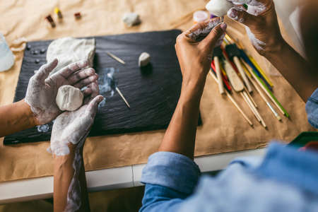 Mother and daughter spend time together and sculpting from clay at home