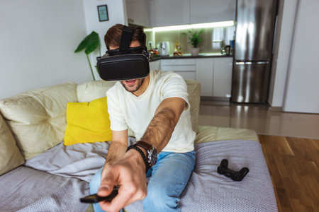 Man wearing virtual reality goggles in the living room.