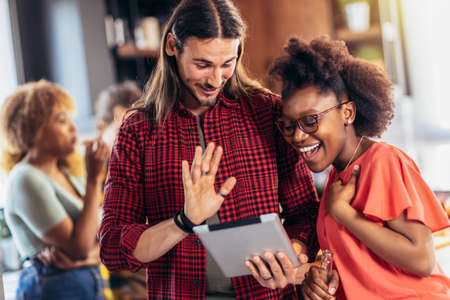 Couple feeling entertained while watching tablet.