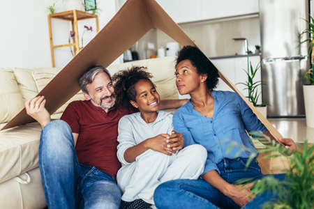 Portrait of a beautiful happy and smiling family just arrived in the new house to start a new journey together.の写真素材