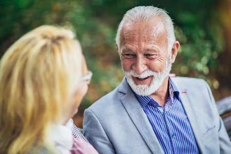 Portrait of beautiful senior couple posing in the parkの写真素材