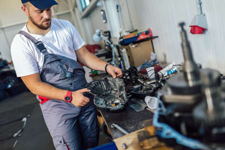 Technician working on checking and service car in workshop garage; technician repair and maintenance engine of automobile in car serviceの写真素材