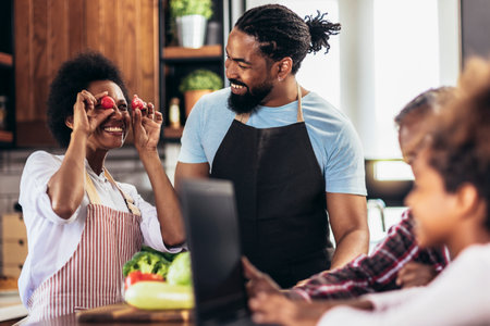 Happy multigenerational african american family make dinner together.の写真素材