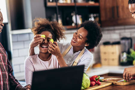 Happy multigenerational african american family make dinner together.の写真素材