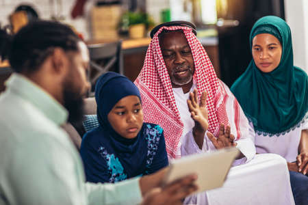 Real estate agent  discussing with a arab family who signs a contract for the purchase of an...