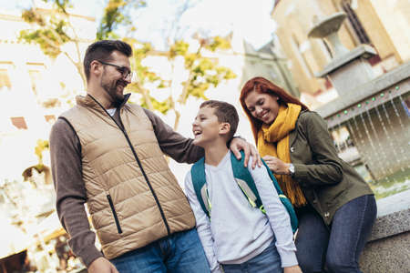 Young parents taking their little child to schoolの写真素材