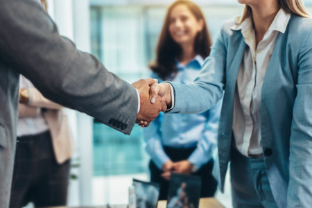 Business people shaking hands in the office. Group of business persons in business meeting.の写真素材