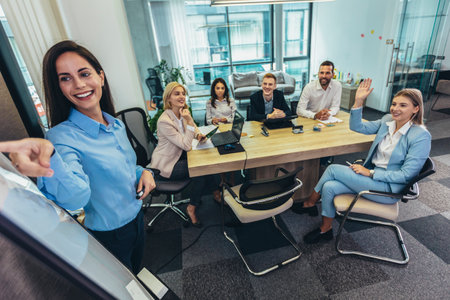 Shot of a businesswoman giving a presentation to her colleagues on a whiteboard in a boardroomの写真素材