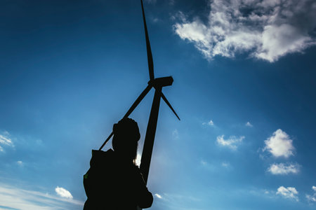Silhouette of engineer at wind turbine electricity industrial