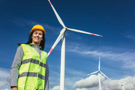 Female engineer on windmill farm for electric power production
