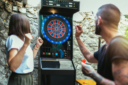 Young attractive couple playing dartsの写真素材