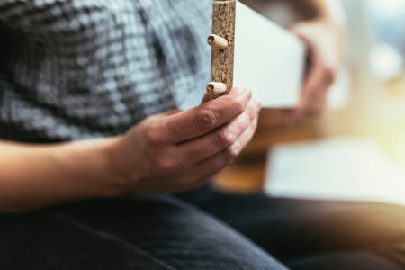 Close-up of hands assembling a new piece of furniture for the living room.の写真素材