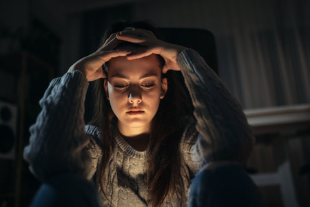 Unhappy depressed teenage girl sitting on floor alone, feeling lonely and misunderstood, stressed sad teenager thinking about troubled, child and psychological problemの写真素材