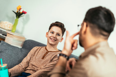 Single father and son spending time together at home and having fun.の写真素材