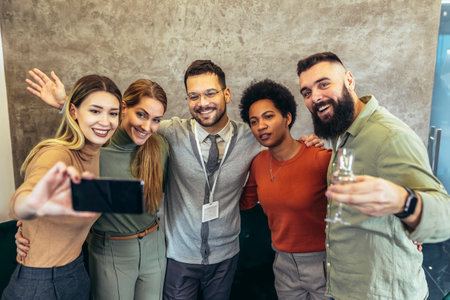 Happy group of coworkers taking a selfie at the office