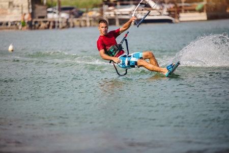 Professional kiter does the difficult trick. A male kiter rides against a beautiful background of...