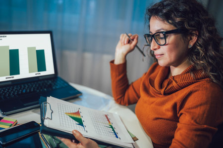 Young beautiful woman working on a laptop in her home officeの写真素材