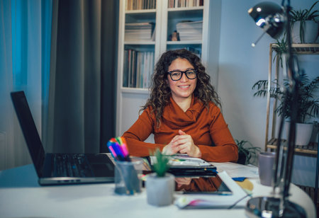 Young beautiful woman working on a laptop in her home officeの写真素材