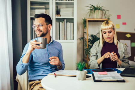 Portrait of young business people working together in home office. Couple teamwork startup conceptの写真素材