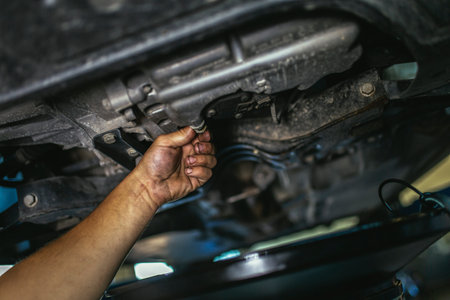 Professional near the car hanging on the lift at the service station make a diagnosticsの写真素材