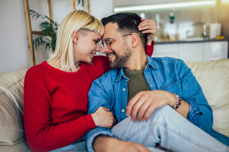 Beautiful couple hugging and relaxing on sofa. Love,happiness,people and fun concept.の写真素材