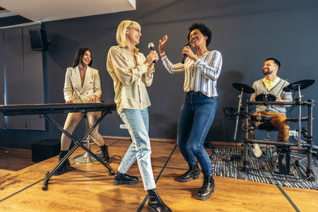 Business people making team training exercise during team building seminar singing karaoke.の写真素材