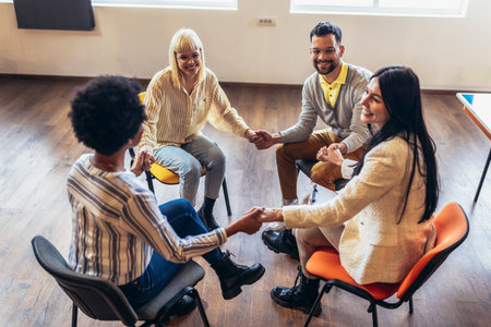 Group of people sitting in a circle are participating in a support meeting. Healthcare and medicine concept.の写真素材