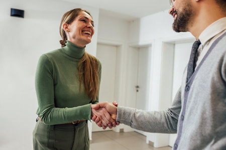 Shot of a young businessman shaking hands with a womanの写真素材