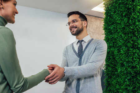 Shot of a young businessman shaking hands with a womanの写真素材