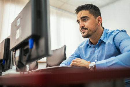 Male student using desktop PC in computer labの写真素材