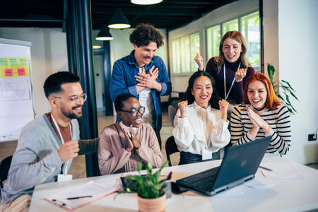 Multiethnic coworkers have an online meeting with their boss.They are hearing some exciting news and are very happyの写真素材